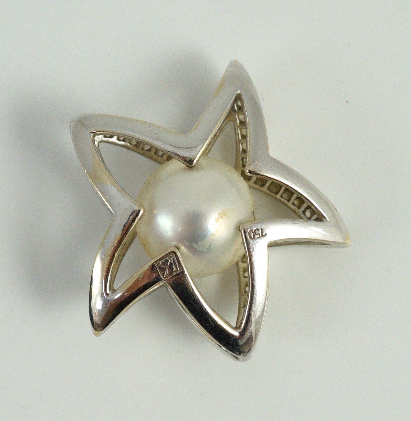 A modern Australian Kailis 18k white gold, single stone South Sea pearl and diamond chip cluster set 'Icon Star' pendant